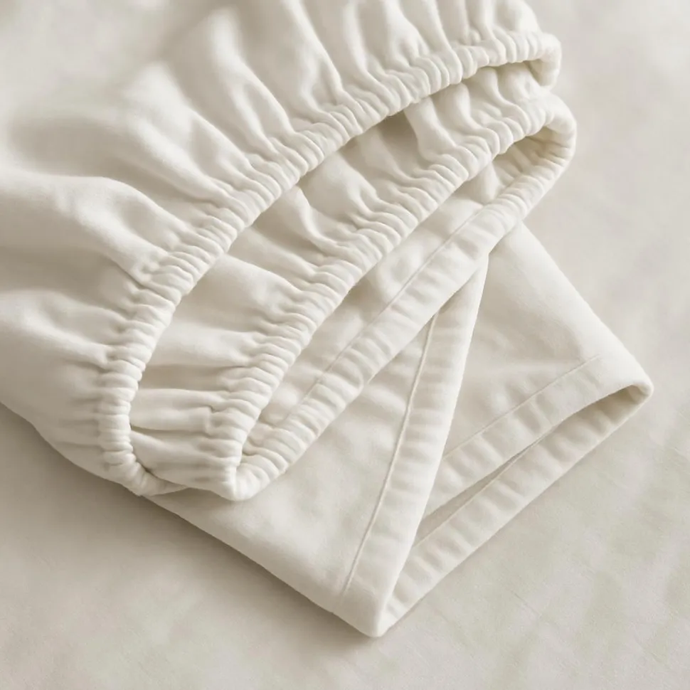 Close-up of folded fitted sheet corners neatly nested
