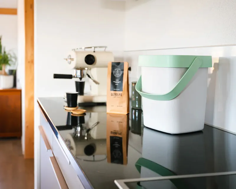 Stylish compost bin on a kitchen counter