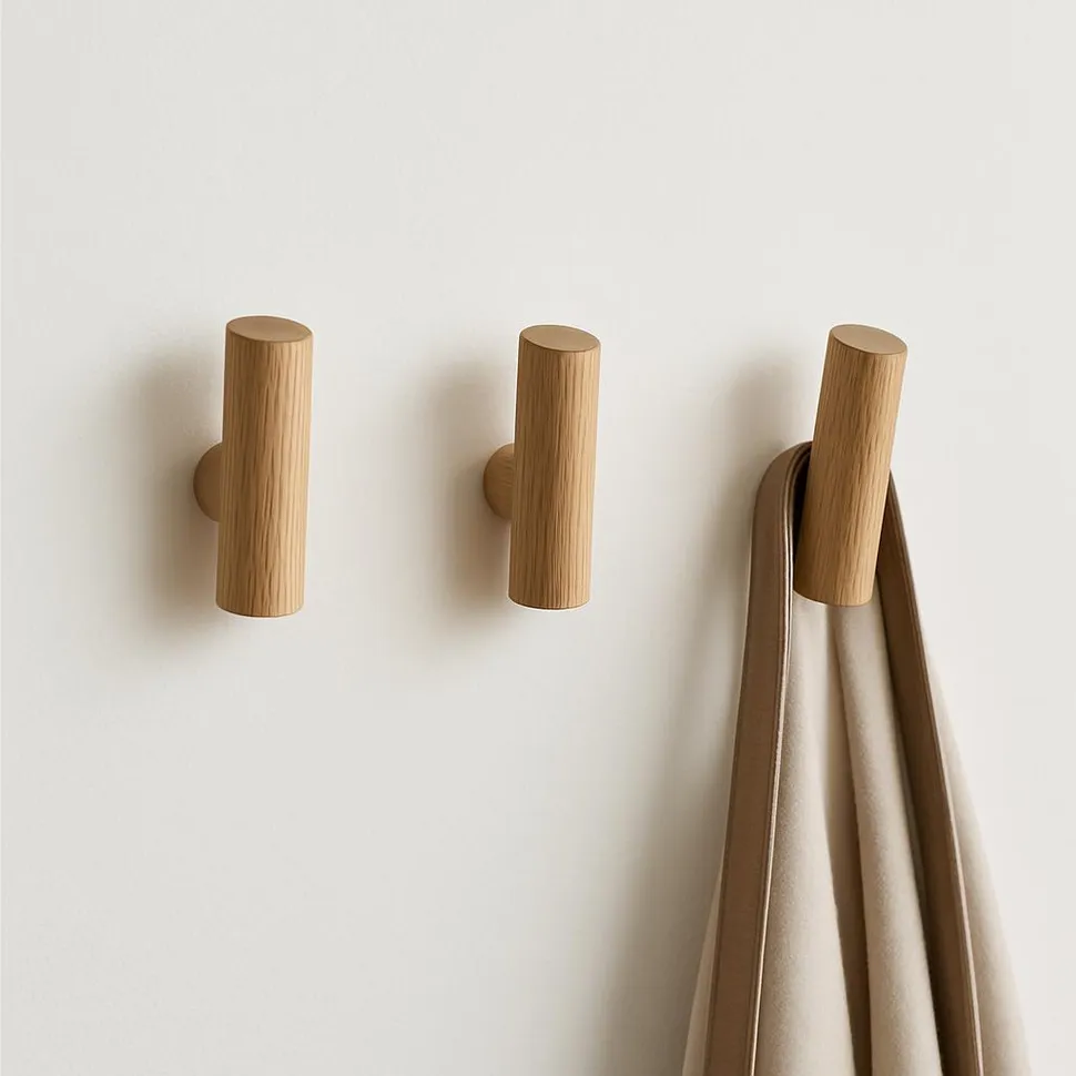 Minimal wooden wall hooks ready for a simple valet system.