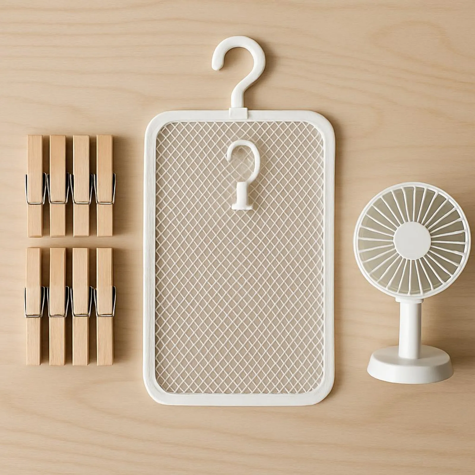 Neatly arranged laundry tools: clothespins, mesh rack, and a small fan